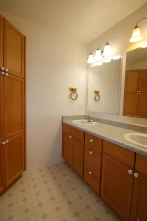 a bathroom with a double vanity sink and a mirror