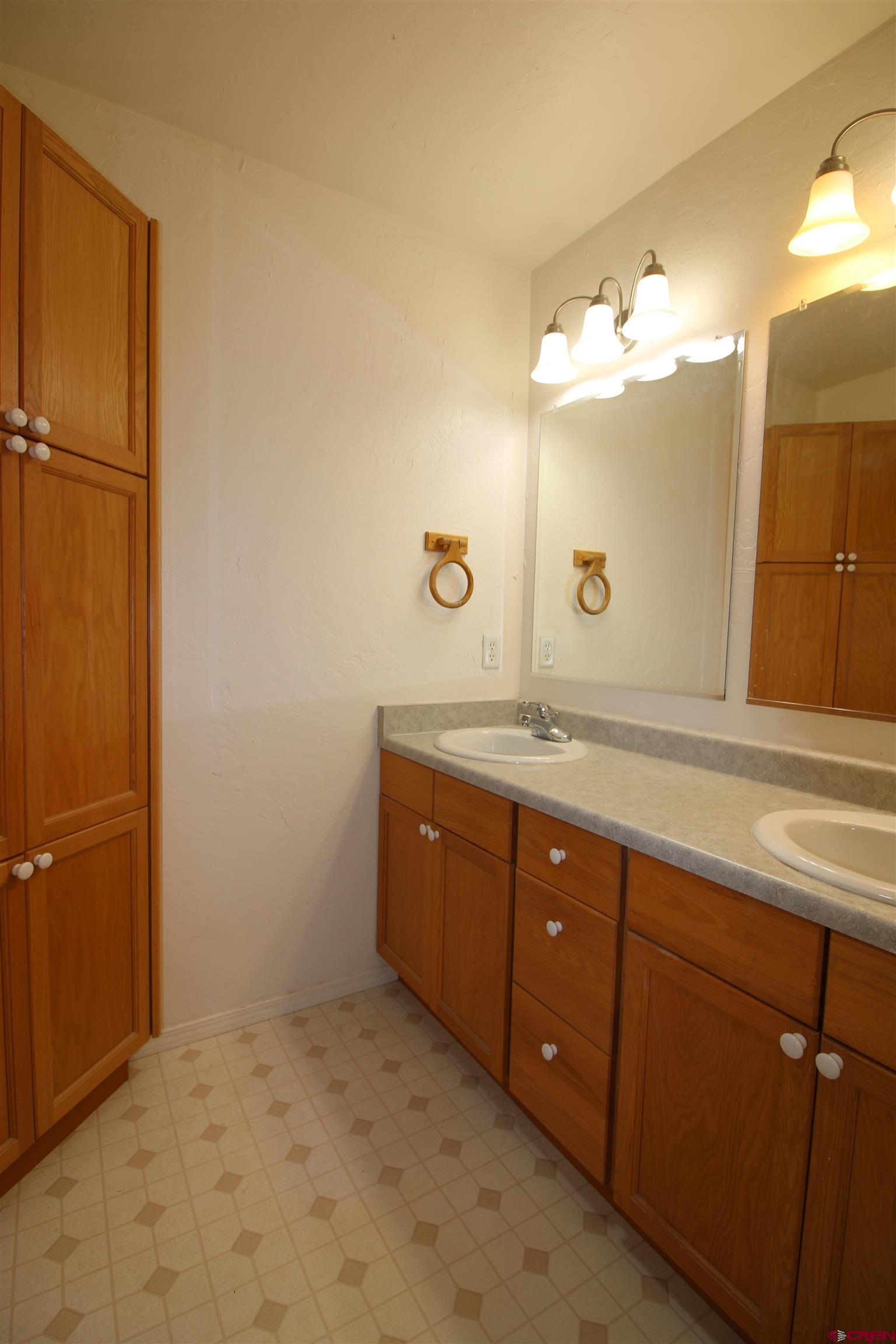 185-165 Northwest 11th Street Cedaredge, CO 81413 - Photo 19 of 34 a bathroom with a double vanity sink and a mirror