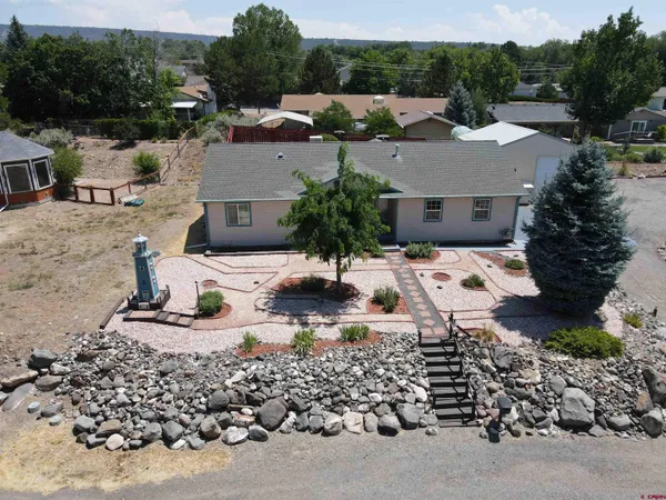 an aerial view of a house with a yard