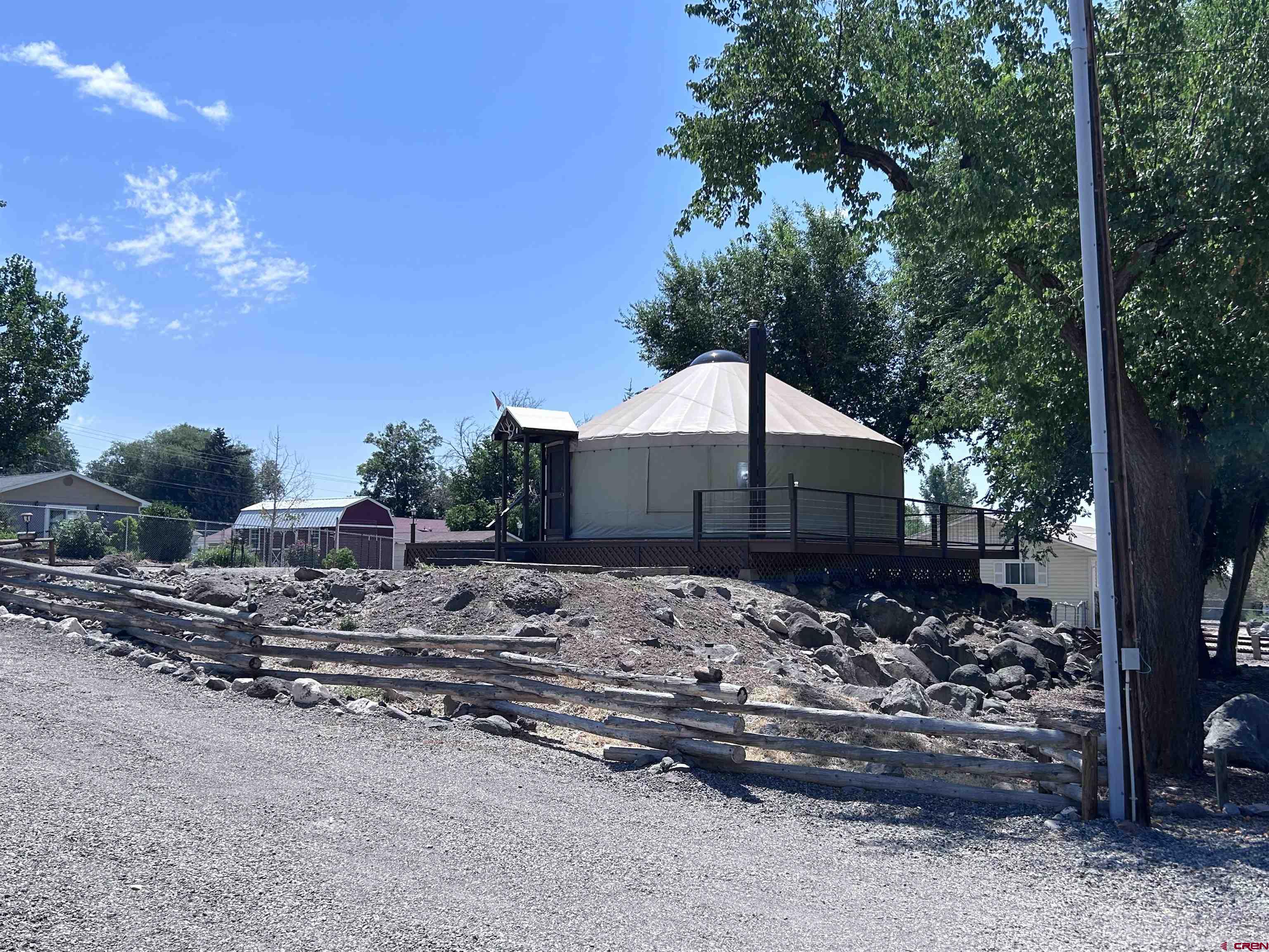 185-165 Northwest 11th Street Cedaredge, CO 81413 - Photo 27 of 34 a wooden house with a large tree in front of it