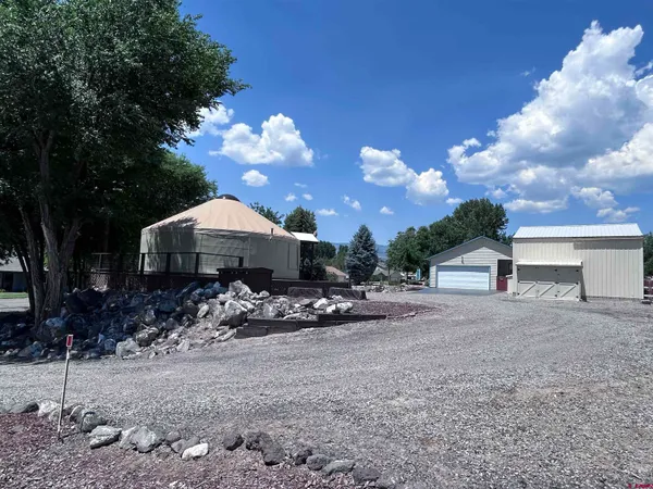 a view of a house with a yard and tree s