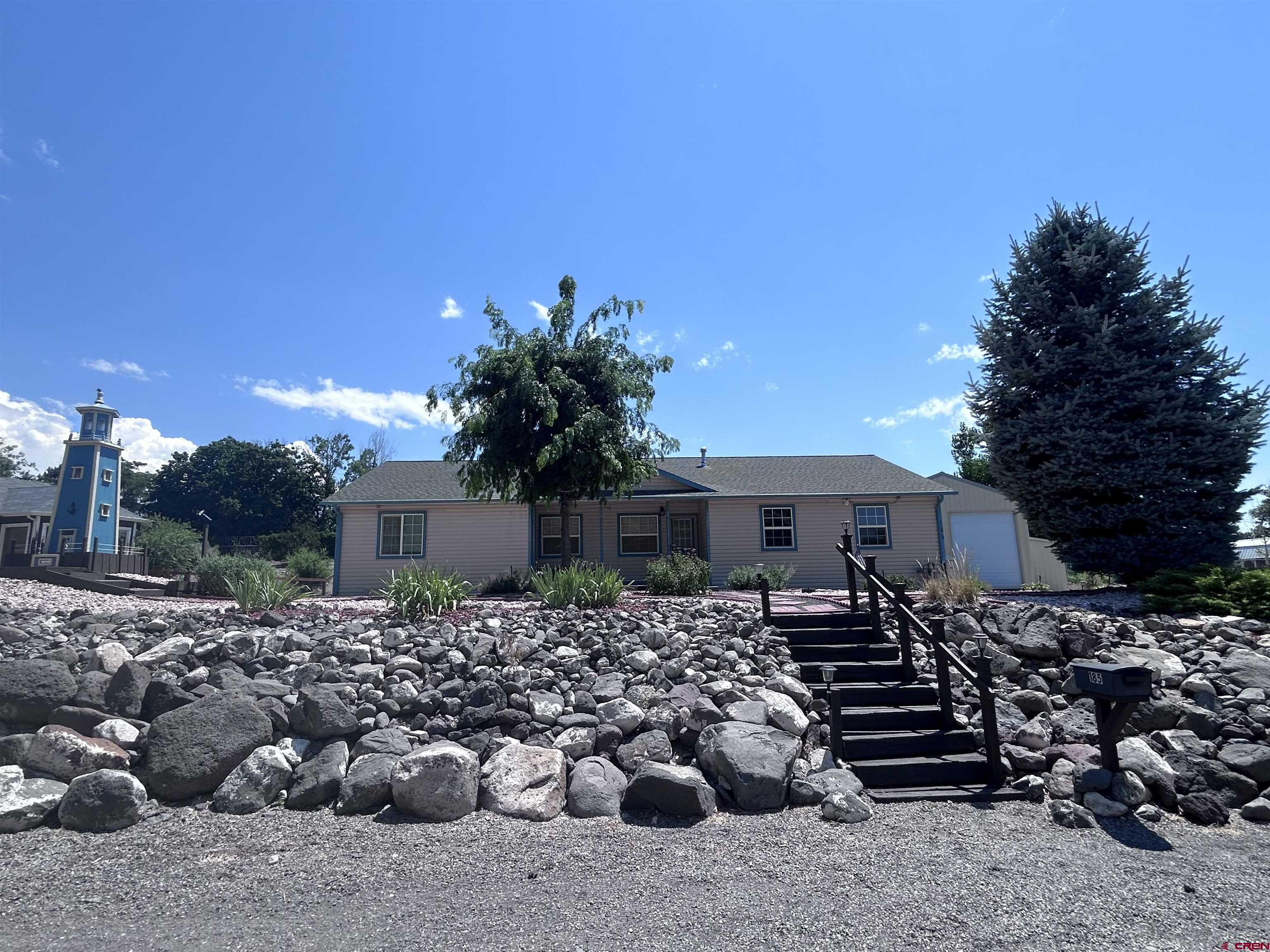 185-165 Northwest 11th Street Cedaredge, CO 81413 - Photo 3 of 34 a front view of a house with a yard