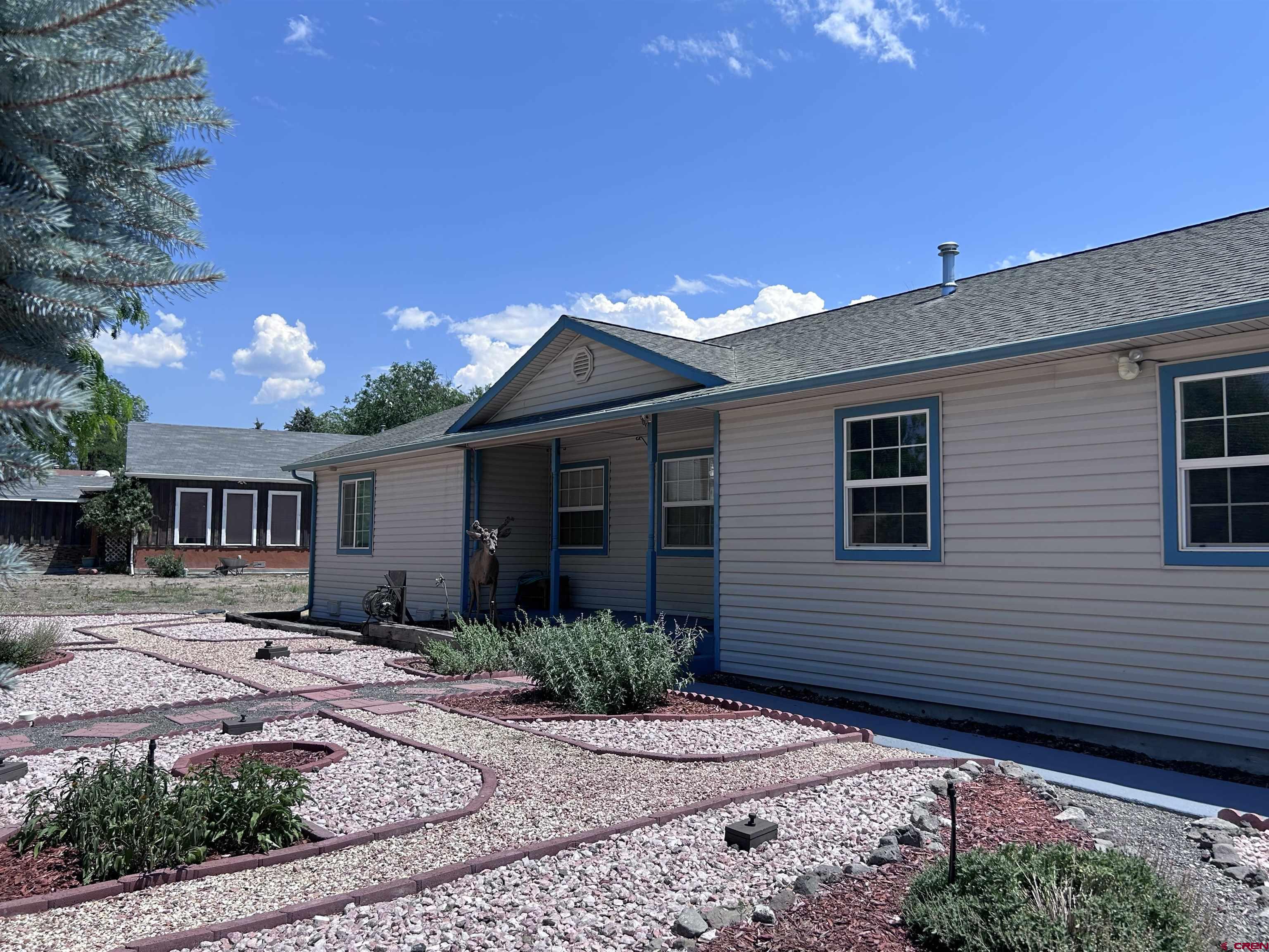 185-165 Northwest 11th Street Cedaredge, CO 81413 - Photo 7 of 34 a front view of a house with garden