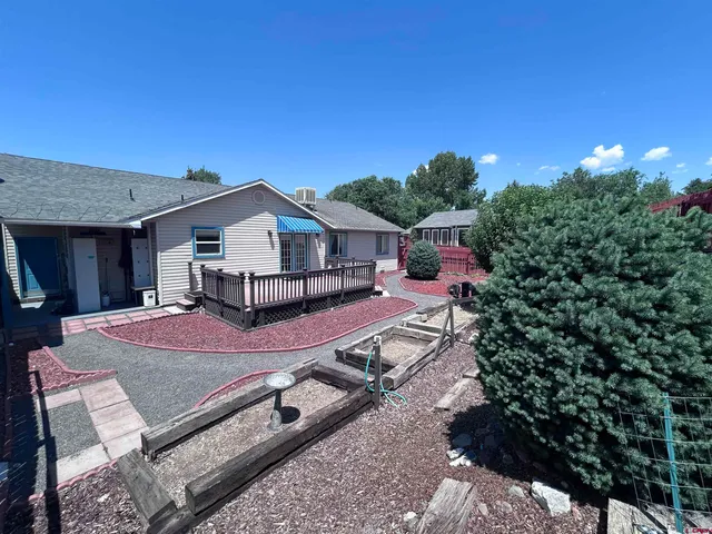 a view of a house with backyard and sitting area