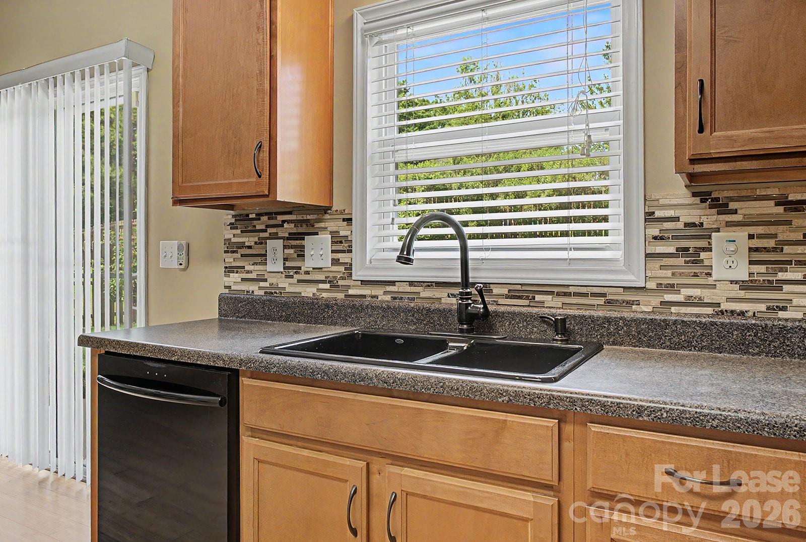 2917 Liddington Road Matthews, NC 28105 - Photo 13 of 44 a kitchen with granite countertop a sink and a window