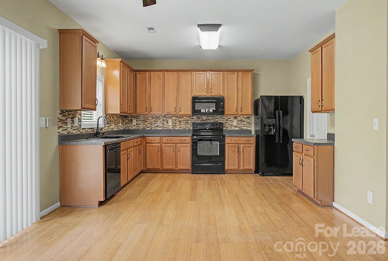 2917 Liddington Road Matthews, NC 28105 - Photo 14 of 44 a kitchen with stainless steel appliances granite countertop a stove cabinets and refrigerator