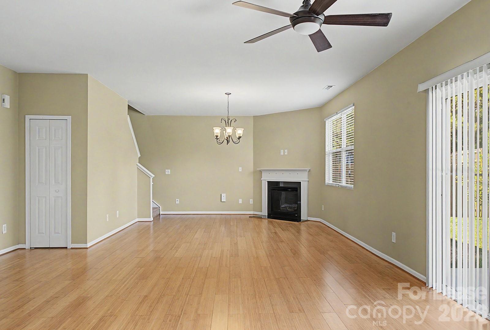 2917 Liddington Road Matthews, NC 28105 - Photo 15 of 44 an empty room with chandelier fan and windows