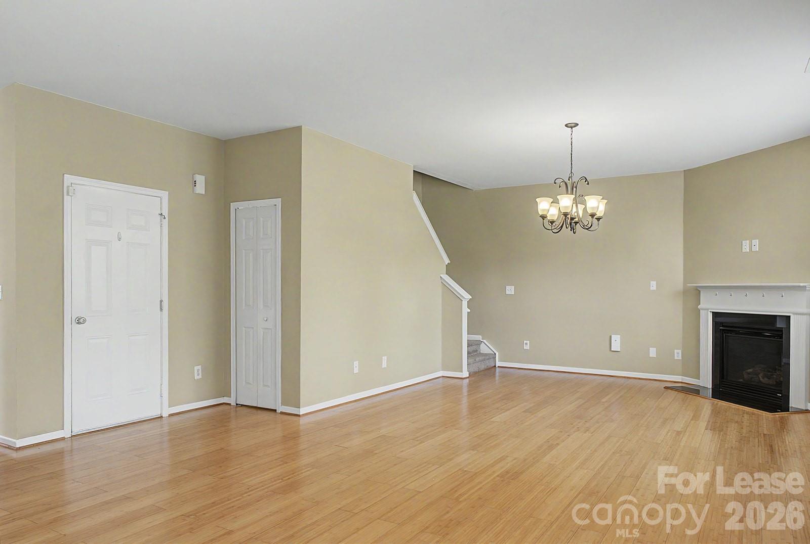 2917 Liddington Road Matthews, NC 28105 - Photo 16 of 44 an empty room with wooden floor chandelier and entryway