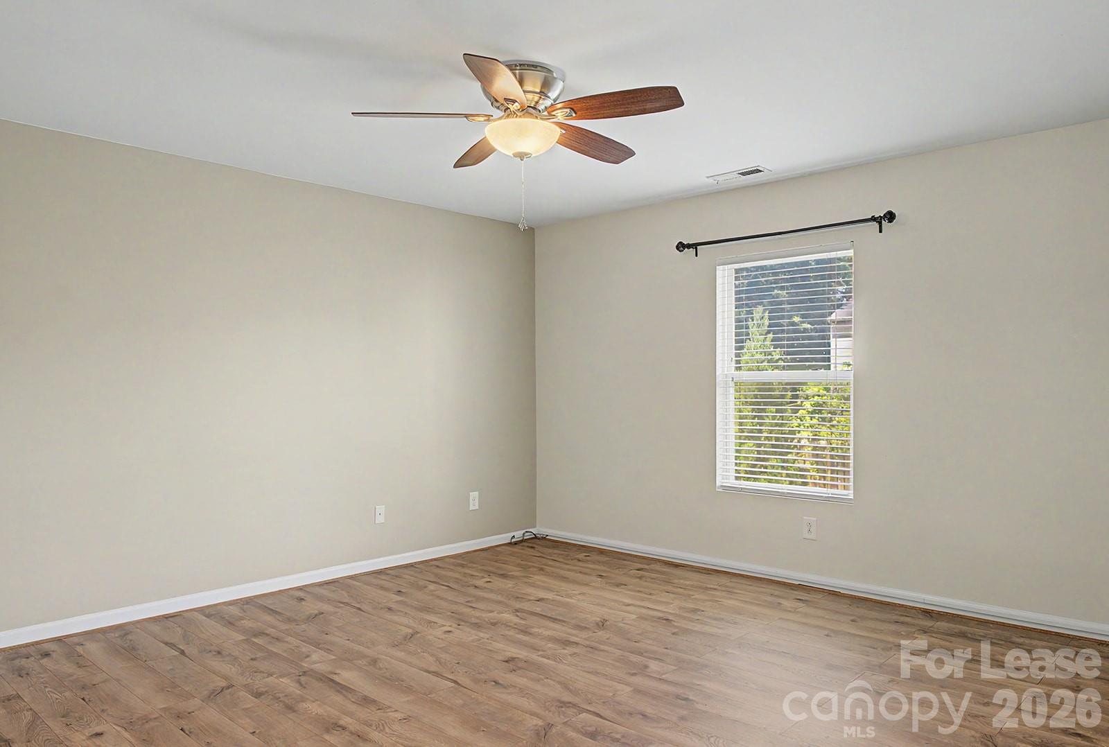 2917 Liddington Road Matthews, NC 28105 - Photo 19 of 44 an empty room with a window and a ceiling fan