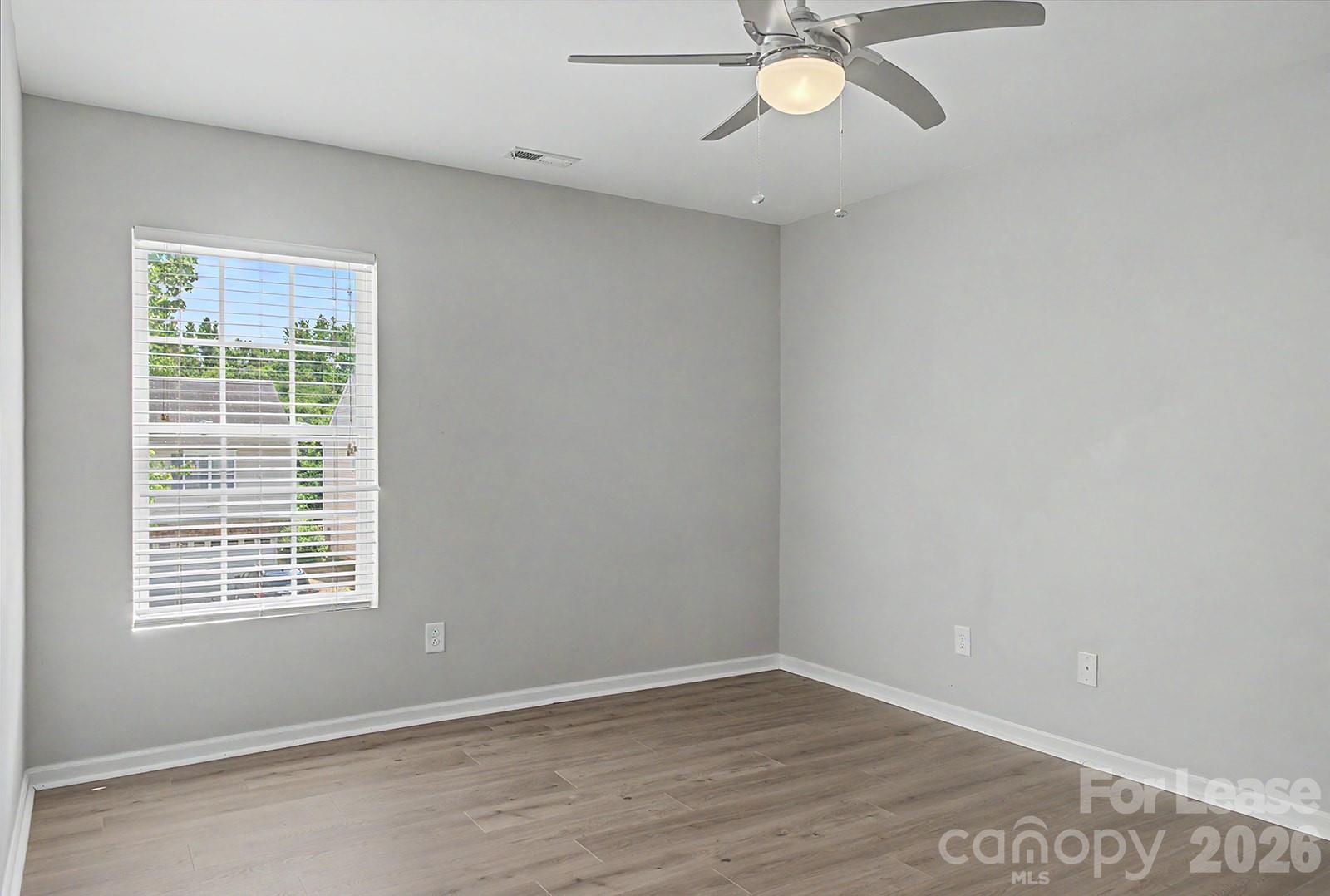 2917 Liddington Road Matthews, NC 28105 - Photo 24 of 44 an empty room with a window and a fan