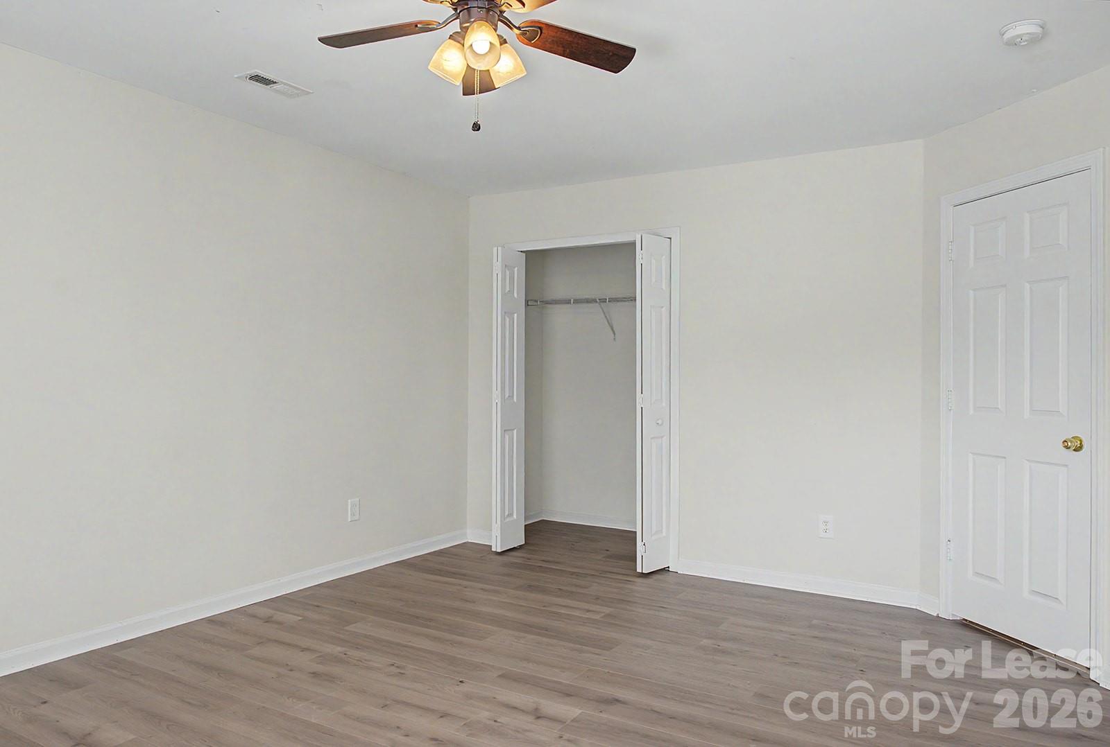 2917 Liddington Road Matthews, NC 28105 - Photo 27 of 44 an empty room with wooden floor and windows