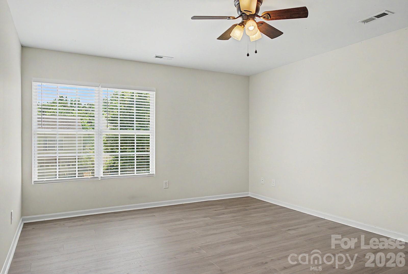 2917 Liddington Road Matthews, NC 28105 - Photo 28 of 44 a view of an empty room with a window and a ceiling fan