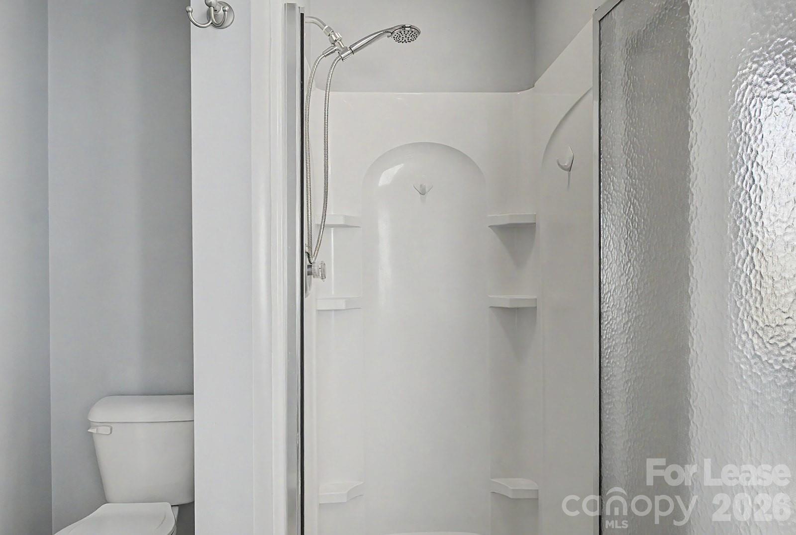 2917 Liddington Road Matthews, NC 28105 - Photo 31 of 44 a bathroom with a glass shower door