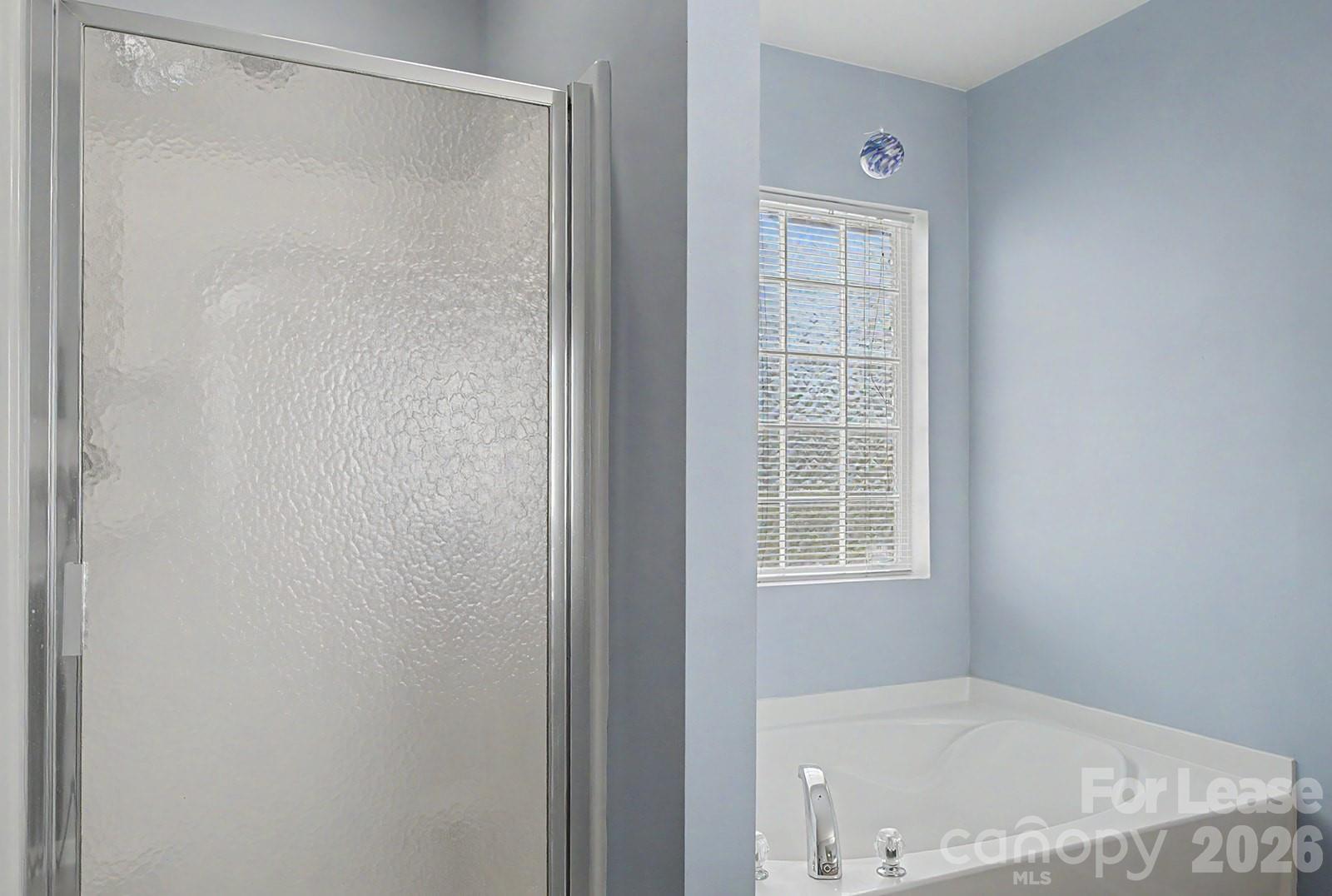2917 Liddington Road Matthews, NC 28105 - Photo 34 of 44 a bathroom with a bathtub and a window