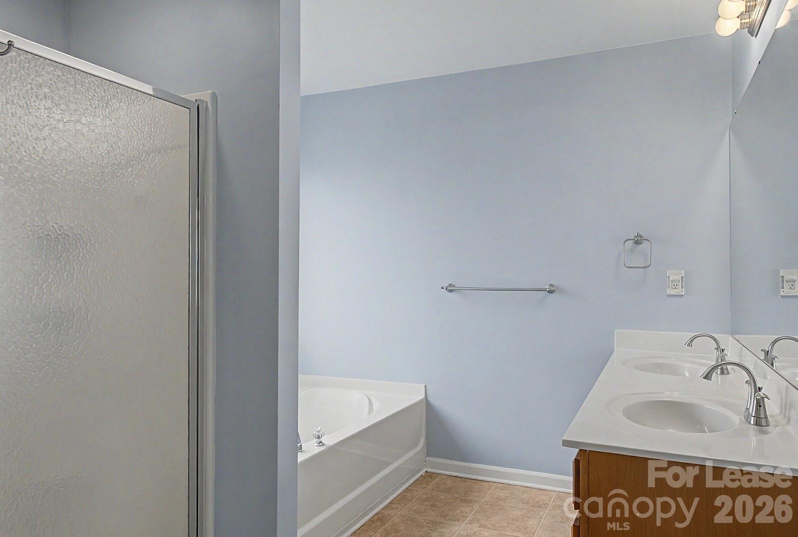 2917 Liddington Road Matthews, NC 28105 - Photo 35 of 44 a bathroom with a sink and a bathtub