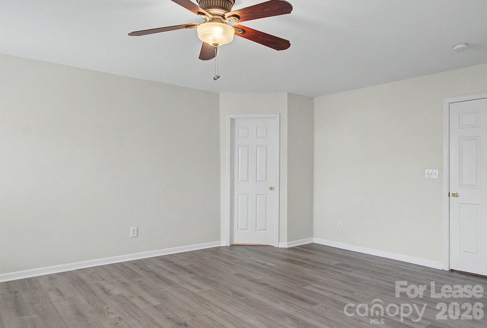 2917 Liddington Road Matthews, NC 28105 - Photo 37 of 44 an empty room with wooden floor fan and windows