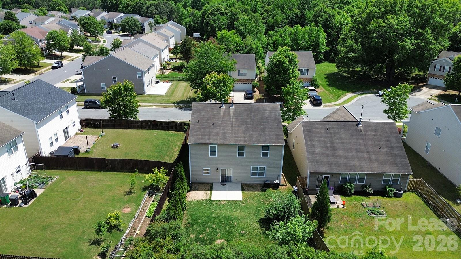 2917 Liddington Road Matthews, NC 28105 - Photo 44 of 44 an aerial view of a house with a garden and swimming pool