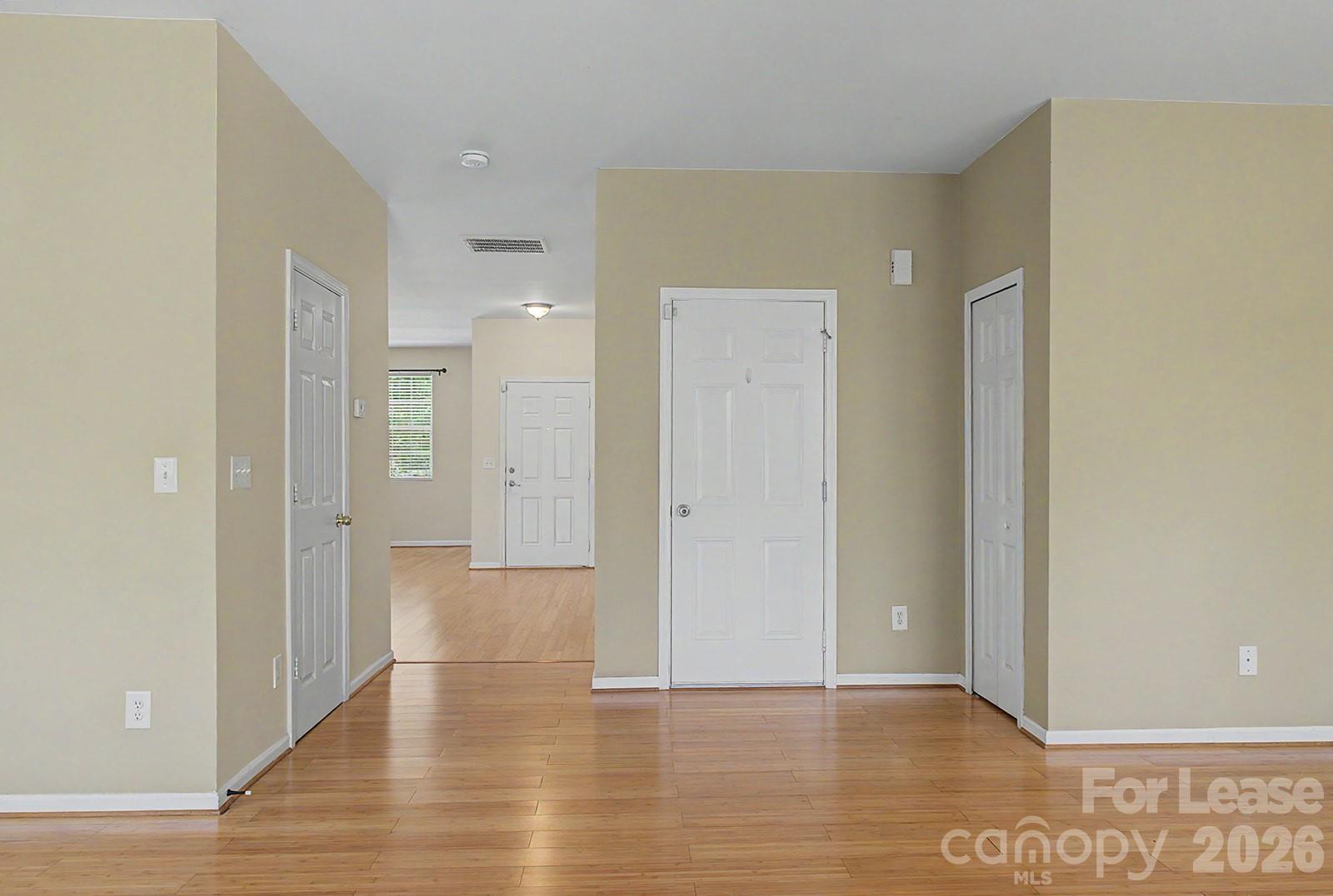 2917 Liddington Road Matthews, NC 28105 - Photo 7 of 44 a view of an empty room with wooden floor and a bathroom