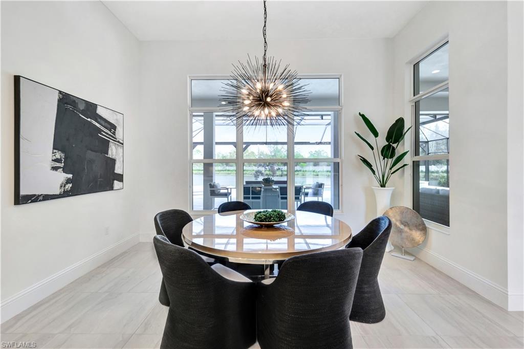 8912 Nevis Way Naples, FL 34112 - Photo 11 of 45 Dining area featuring baseboards and a chandelier