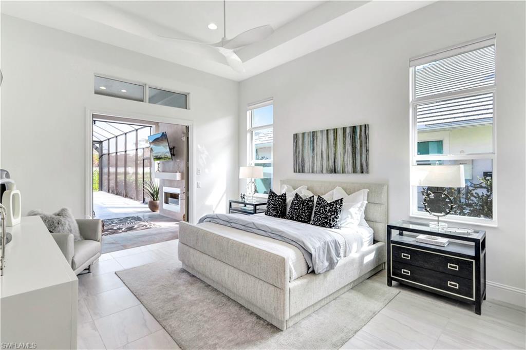8912 Nevis Way Naples, FL 34112 - Photo 13 of 45 Bedroom featuring access to outside, recessed lighting, and a tray ceiling