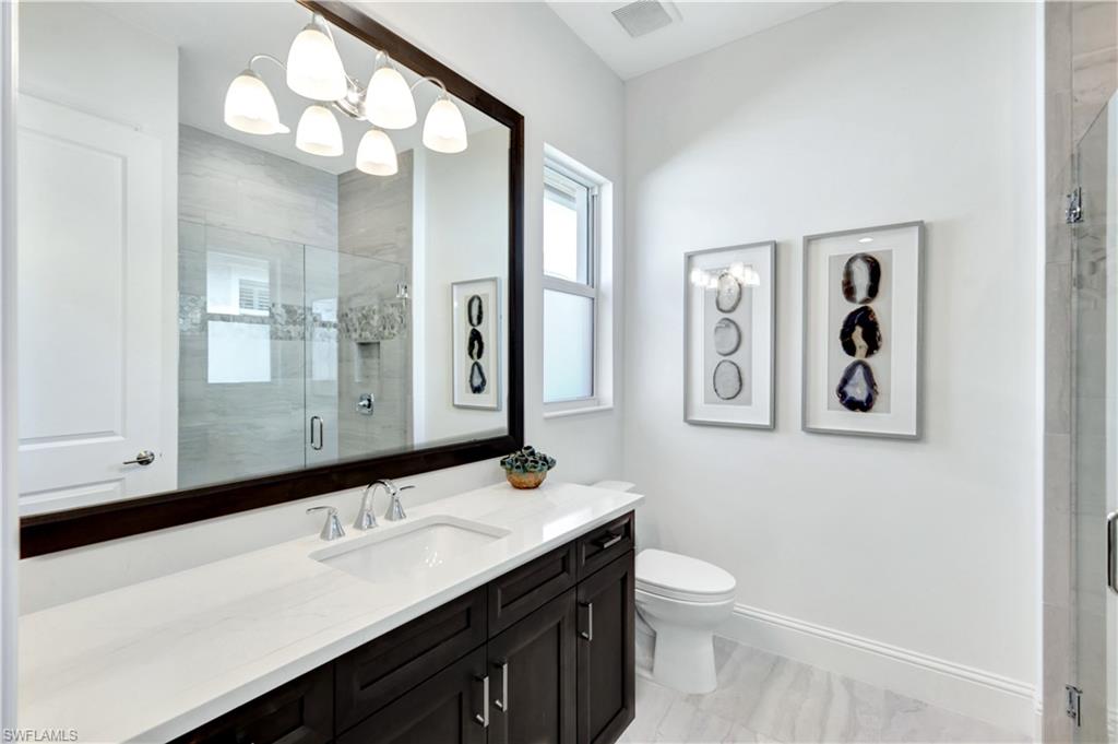 8912 Nevis Way Naples, FL 34112 - Photo 20 of 45 Bathroom with vanity and a shower stall