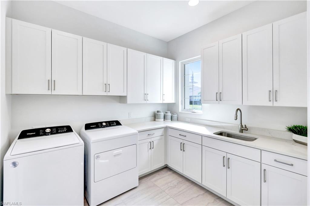 8912 Nevis Way Naples, FL 34112 - Photo 22 of 45 Laundry room featuring independent washer and dryer, cabinet space, and recessed lighting