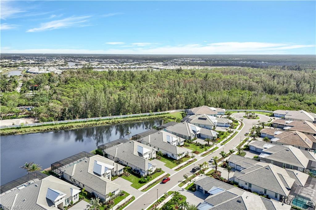 8912 Nevis Way Naples, FL 34112 - Photo 38 of 45 Aerial view of residential area featuring a nearby body of water and a forest