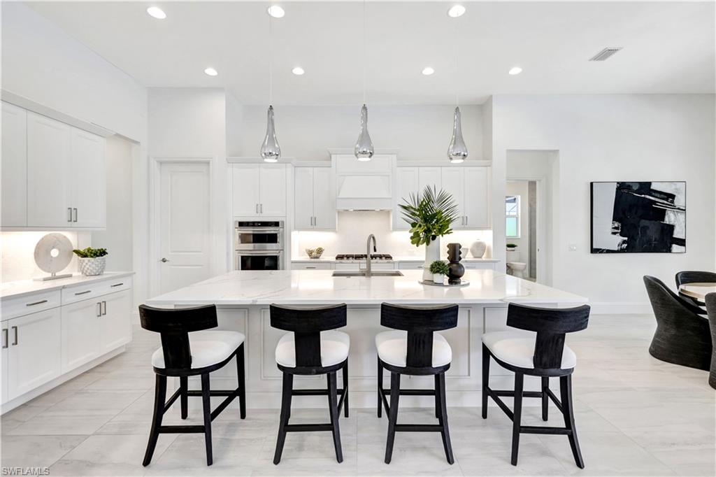 8912 Nevis Way Naples, FL 34112 - Photo 4 of 45 Dining area featuring baseboards and a chandelier