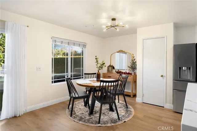 a view of a dining room with furniture window and wooden floor