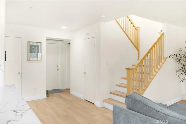 a view of entryway with wooden floor and stairs