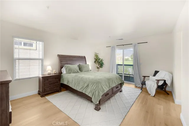 a spacious bedroom with a bed and a window