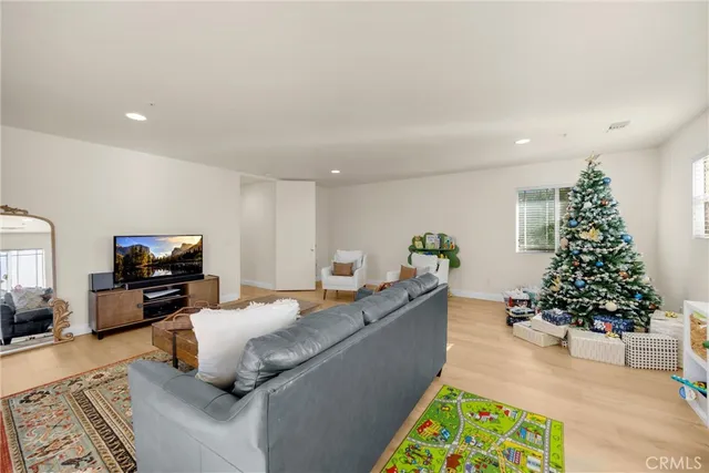 a living room with furniture potted plant and a window