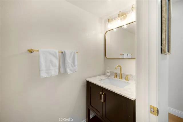 a bathroom with a sink vanity and a mirror