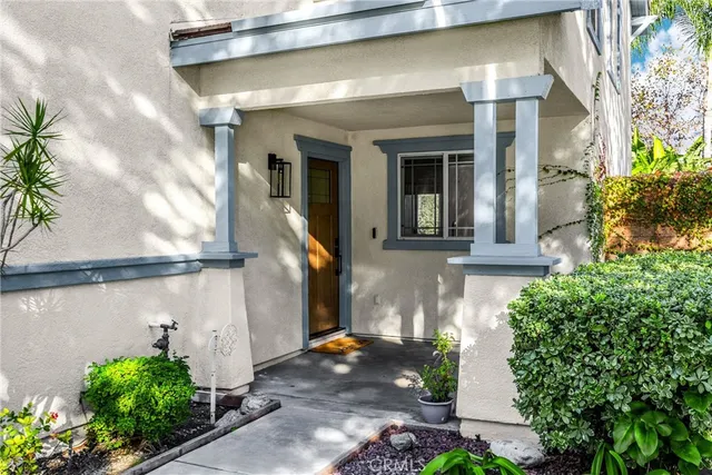 a front view of a house with potted plants