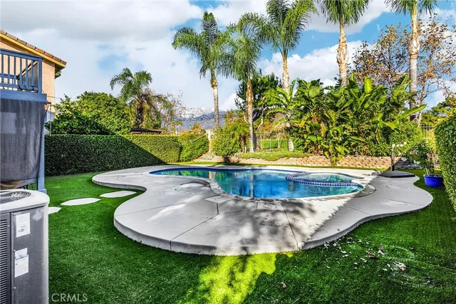 a view of swimming pool with outdoor seating and plants