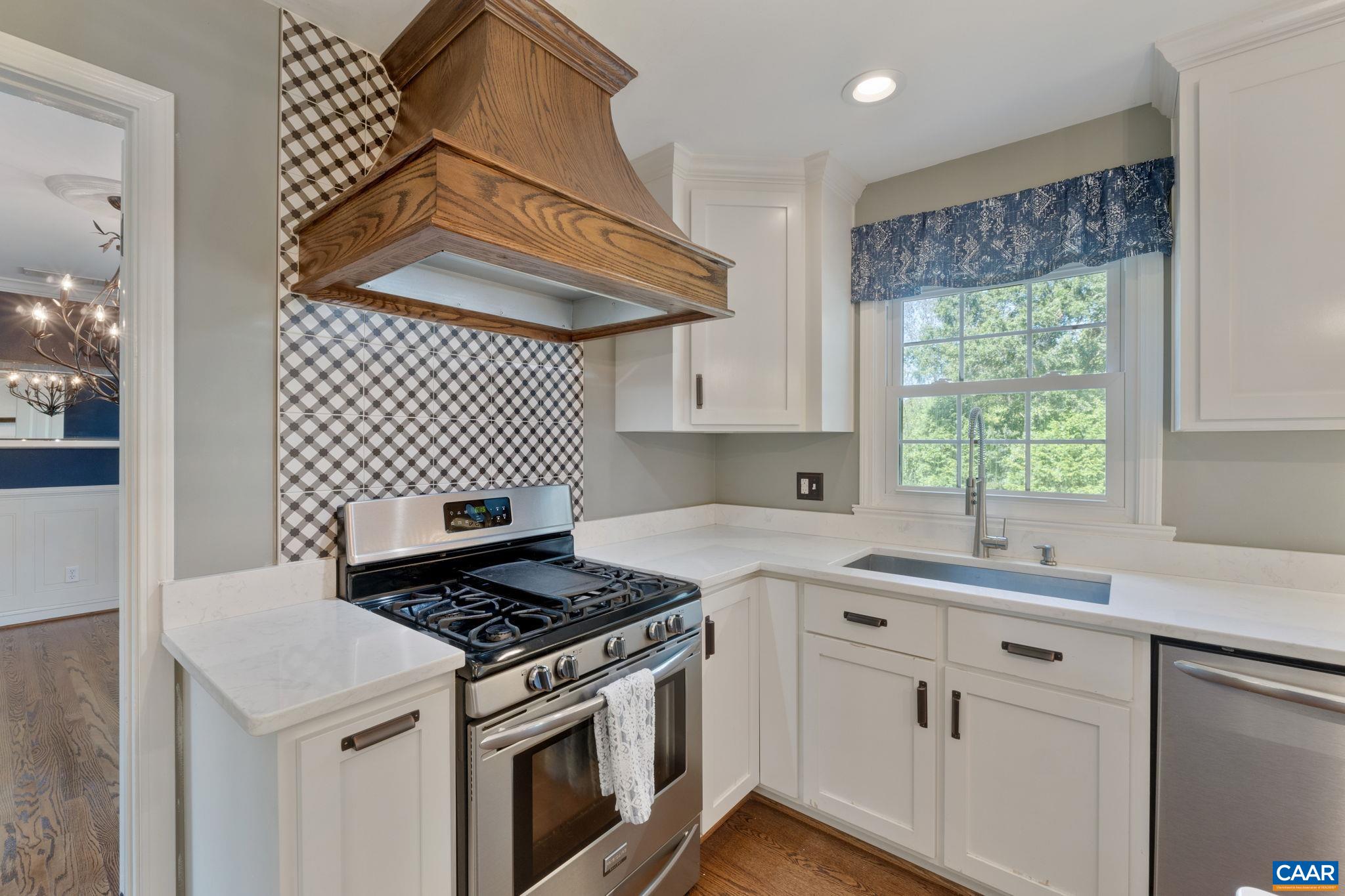 2160 Devonshire Road Charlottesville, VA 22901 - Photo 19 of 43 a kitchen with a stove a sink and a cabinets