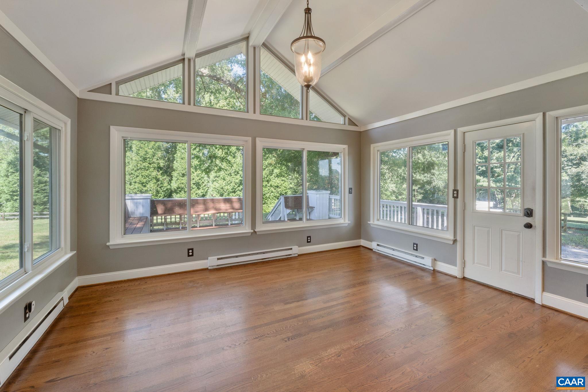2160 Devonshire Road Charlottesville, VA 22901 - Photo 22 of 43 a view of an empty room with wooden floor and a window
