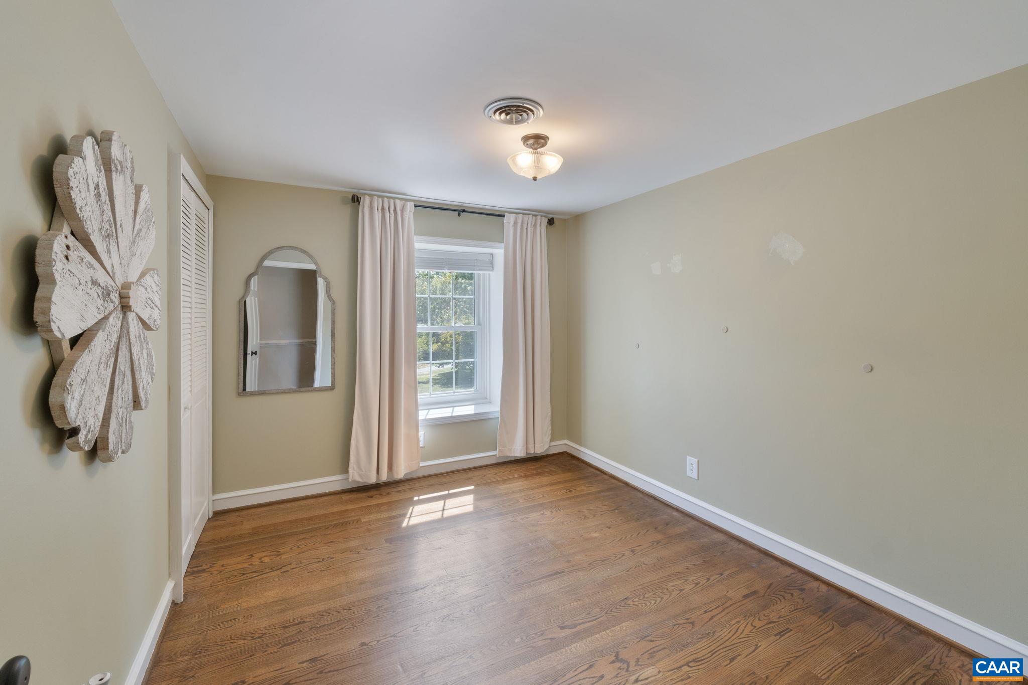 2160 Devonshire Road Charlottesville, VA 22901 - Photo 31 of 43 a view of a hallway with wooden floor and a bathroom