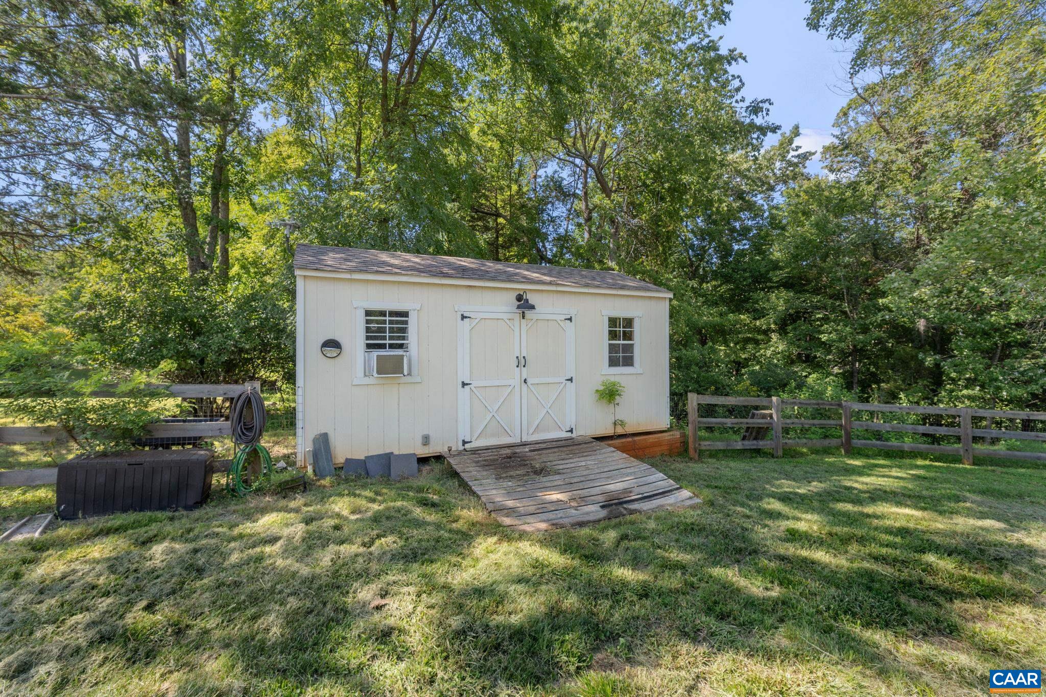 2160 Devonshire Road Charlottesville, VA 22901 - Photo 41 of 43 a backyard of a house with fire pit and trees