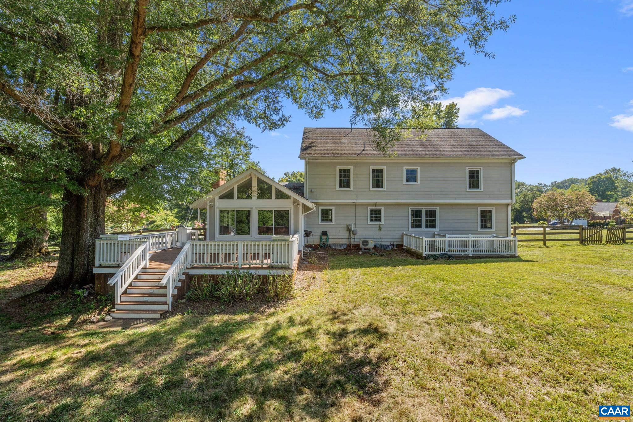 2160 Devonshire Road Charlottesville, VA 22901 - Photo 6 of 43 a front view of a house with a yard fountain and a large tree