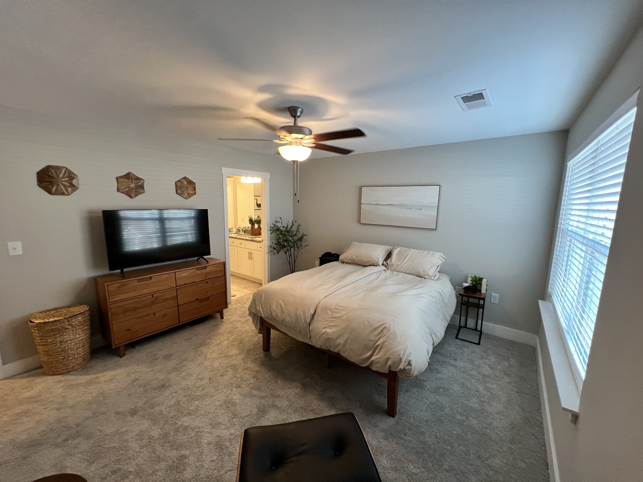 1040 Wells Way Spring Hill, TN 37174 - Photo 12 of 36 a spacious bedroom with a bed and a flat screen tv
