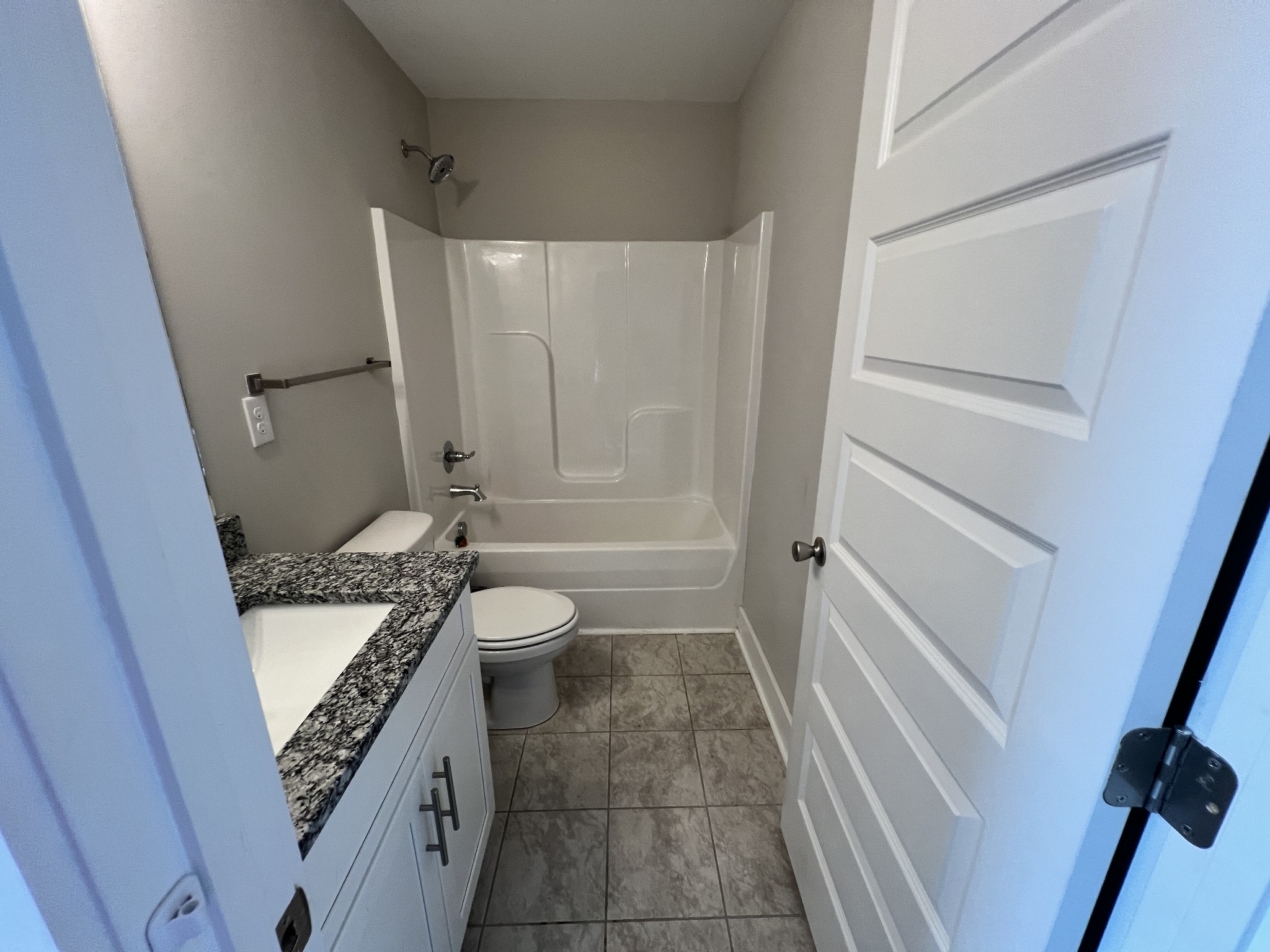1040 Wells Way Spring Hill, TN 37174 - Photo 21 of 36 a bathroom with a granite countertop sink a toilet a tub and shower