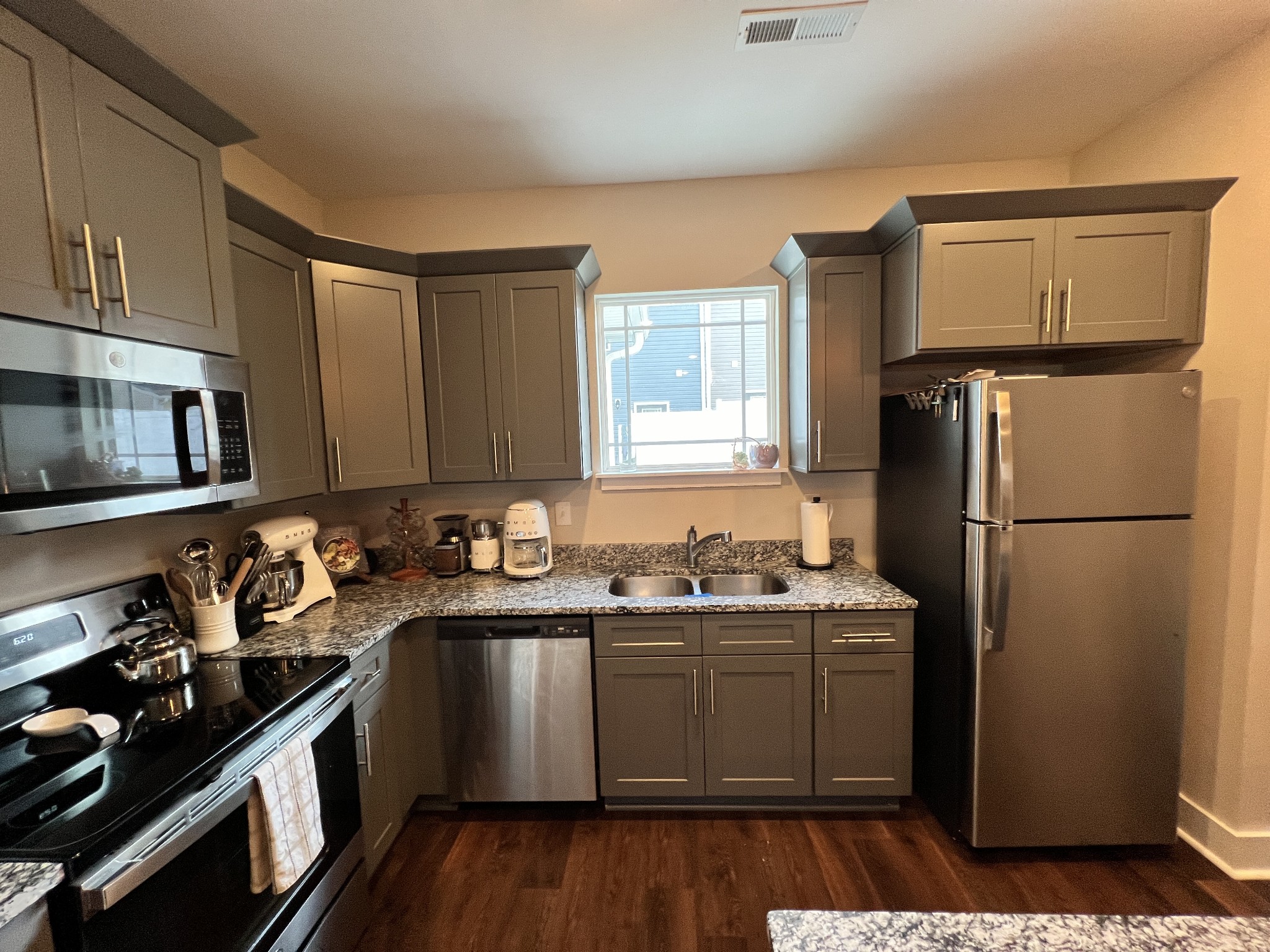 1040 Wells Way Spring Hill, TN 37174 - Photo 6 of 36 a kitchen with a sink stove and refrigerator