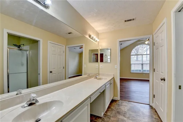 a bathroom with a sink mirror toilet and bathtub