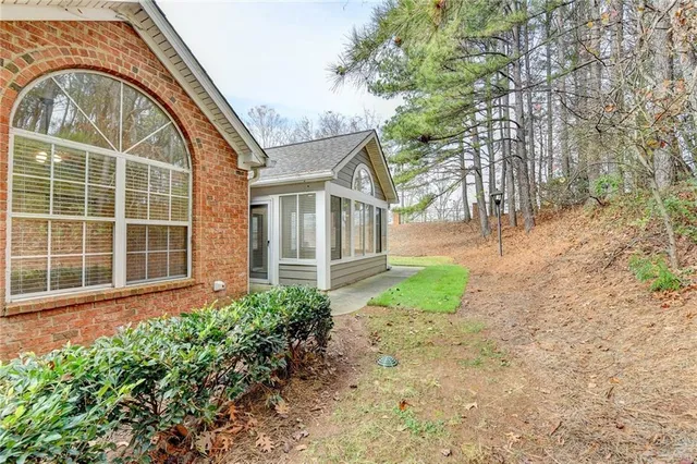 a view of an empty room and window with wooden floor