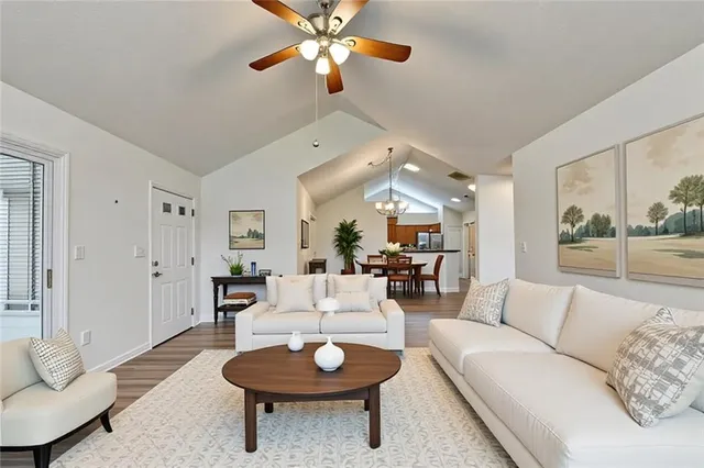 a view of an empty room with wooden floor fireplace and a window