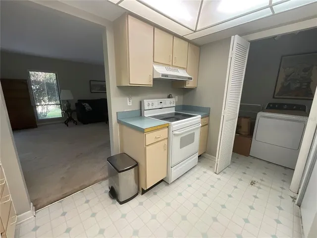 a kitchen with a stove a sink and a refrigerator