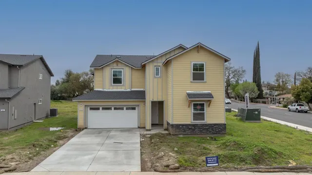 a front view of a house with garden