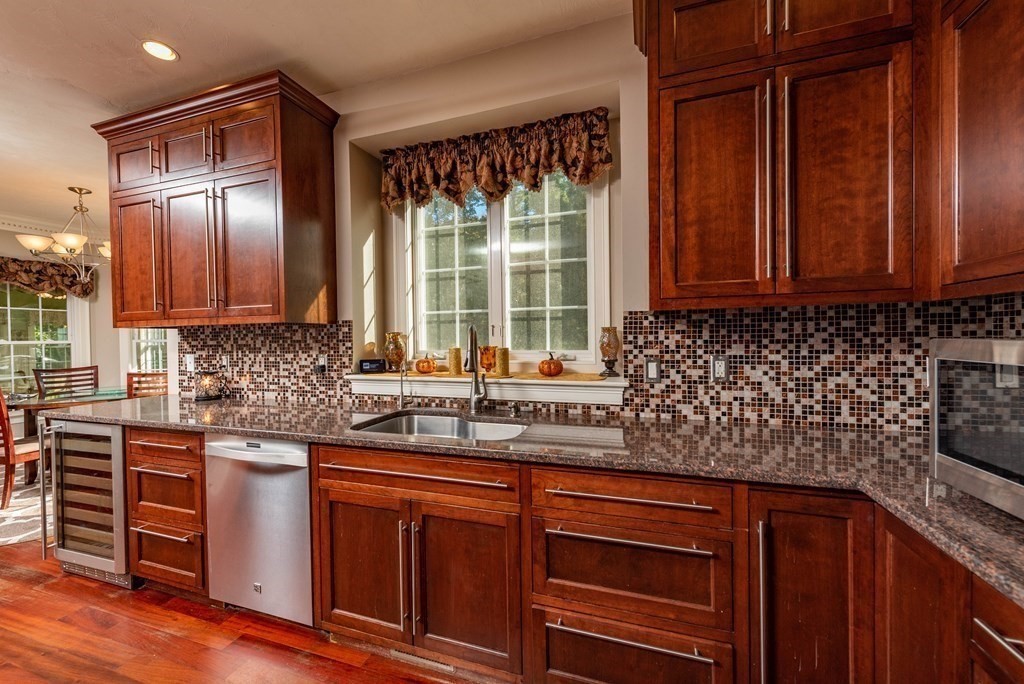63 Bridge Street Raynham, MA 02767 - Photo 13 of 38 a kitchen with stainless steel appliances granite countertop wooden cabinets a sink and dishwasher
