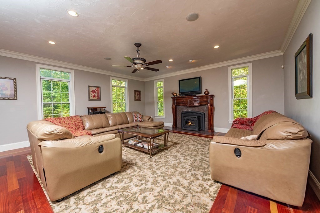 63 Bridge Street Raynham, MA 02767 - Photo 15 of 38 a living room with furniture and a fireplace